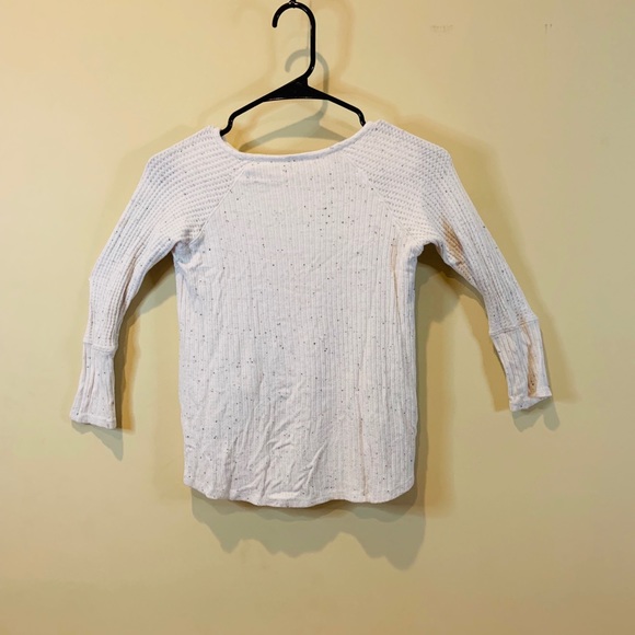 A white shite with black little fuzzys on it - Picture 2 of 2